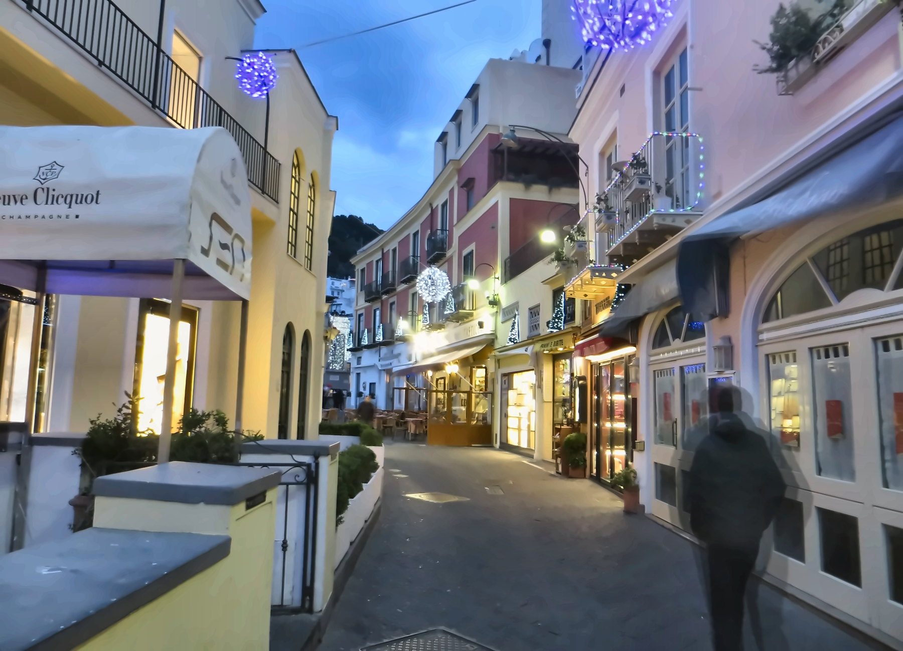 A Christmas-decorated street in Capri at winter dusk