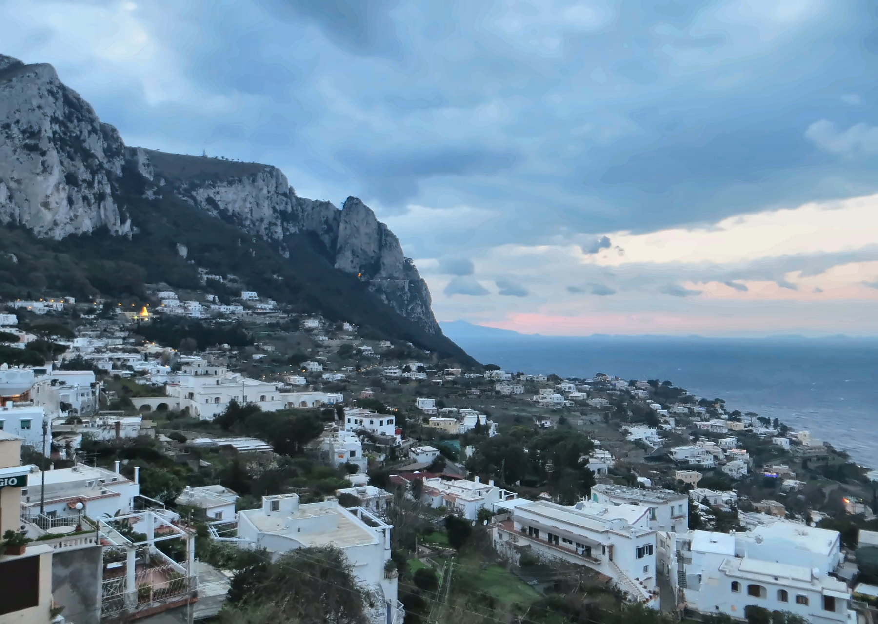 Winter panorama of Capri with cliffs, houses and the sea beneath a grey sky