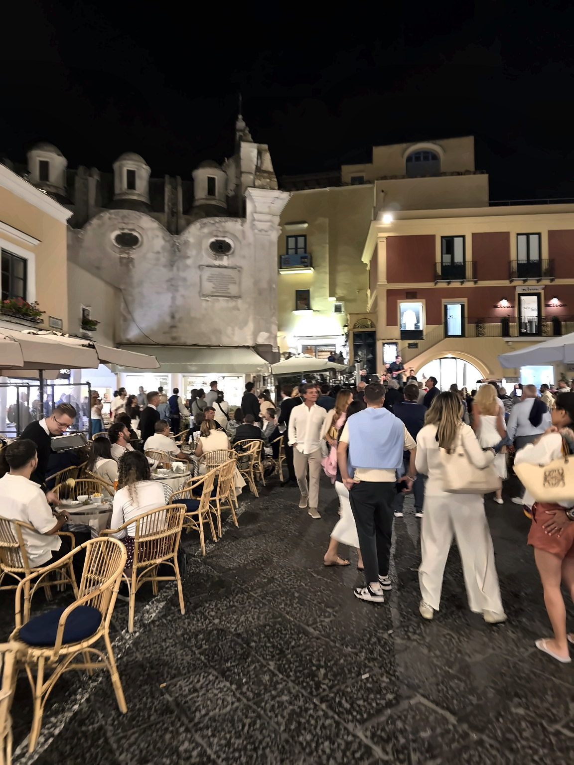 Evening crowds on the Piazzetta in Capri with busy cafés and passers-by