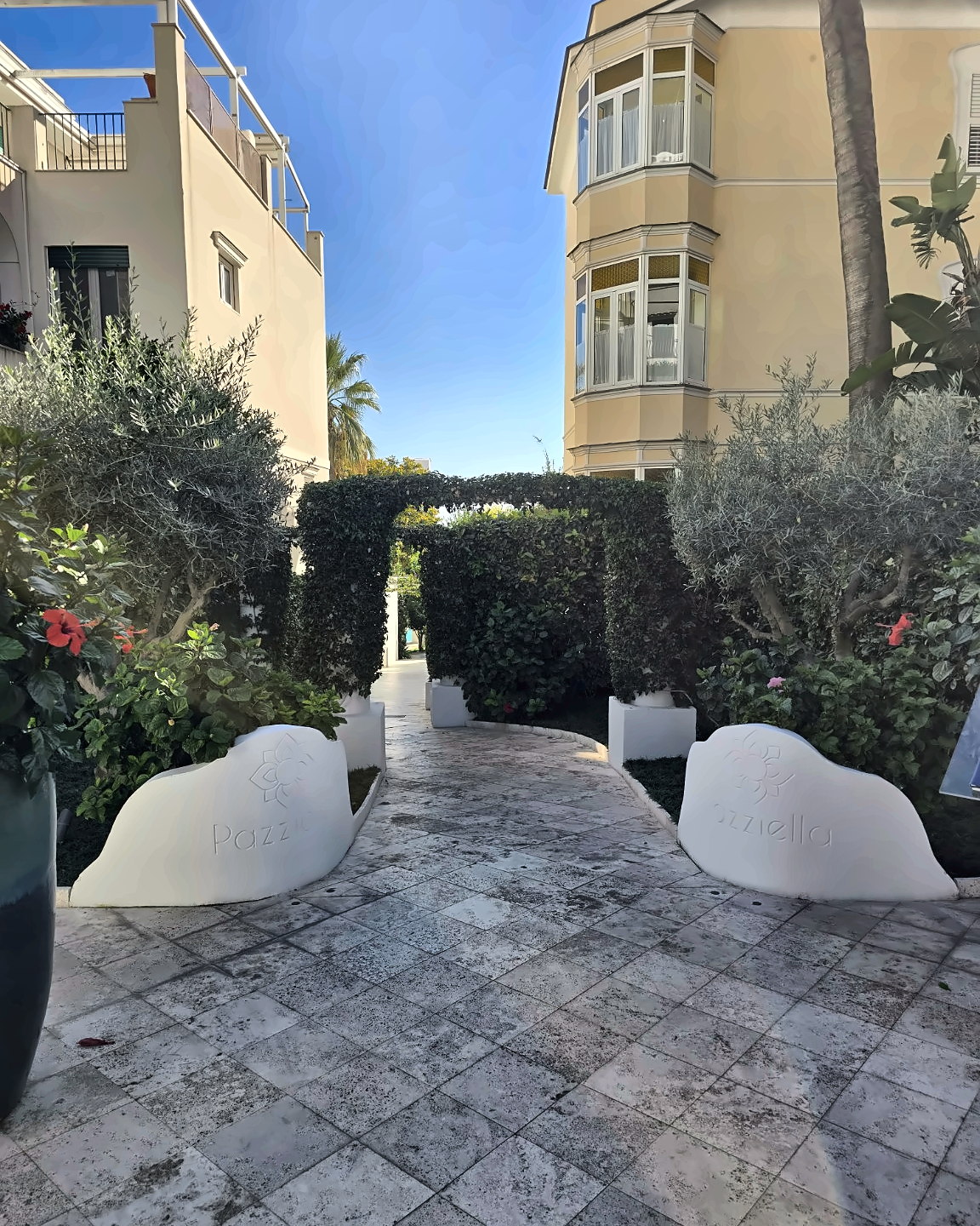 Entrance to Pazziella Capri surrounded by Mediterranean greenery