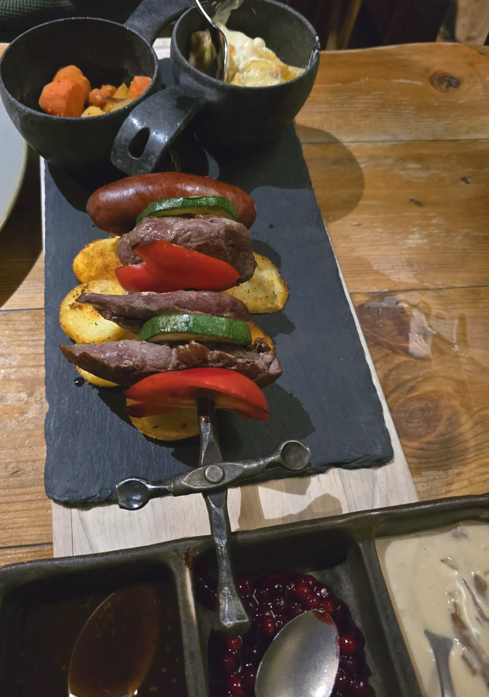 Meat and vegetable skewer served on a slate board at a Viking-themed restaurant in Tampere