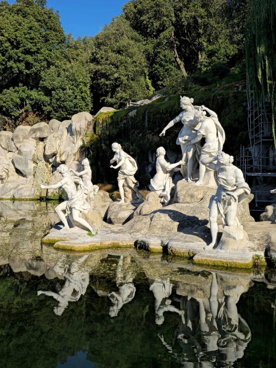 Sculptural group of Diana and the nymphs reflected in the water in the park of the Reggia di Caserta.