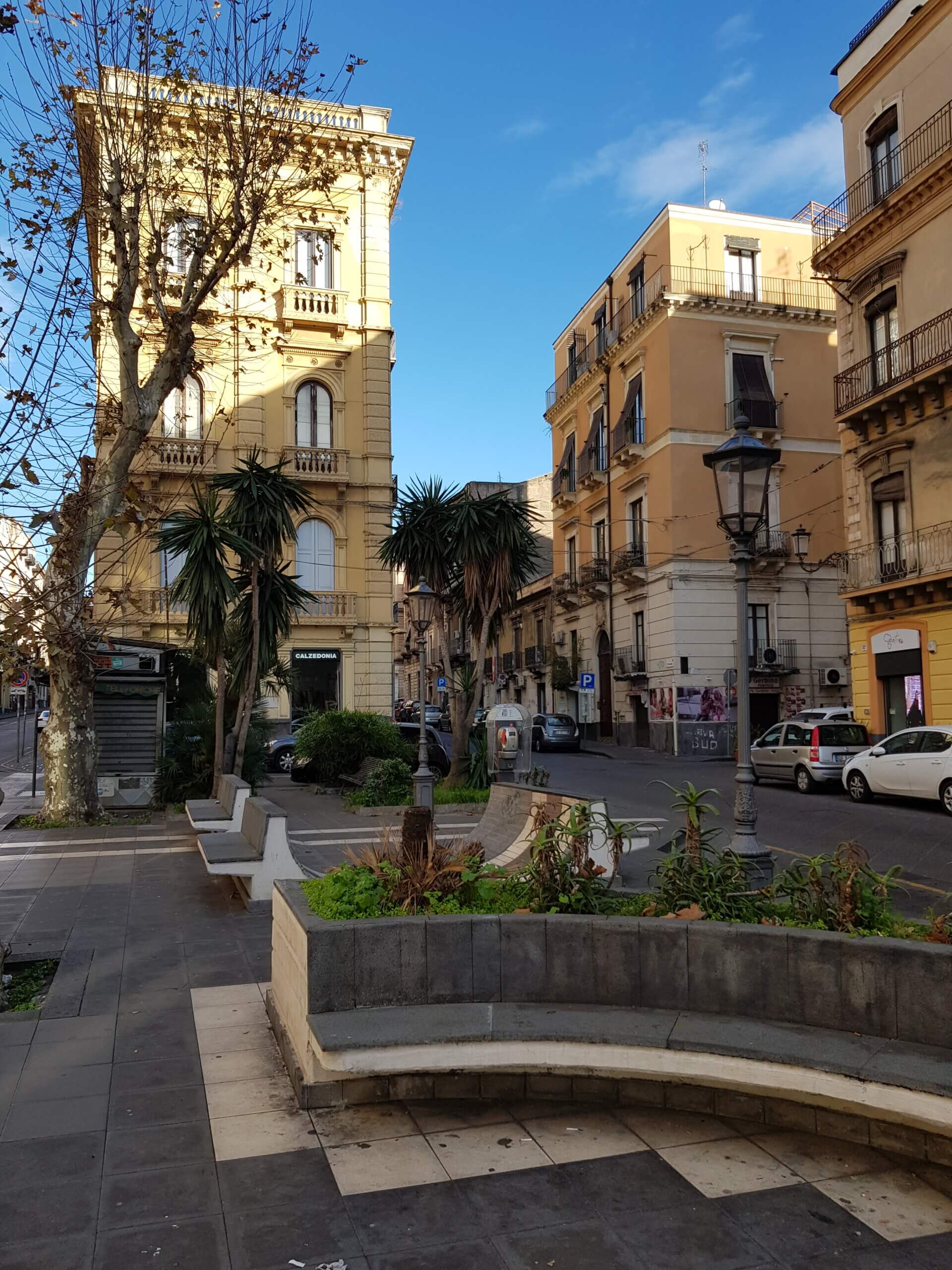 Via Etnea u Cataniji, s pročeljima, palmama i tamnim vulkanskim kamenom.