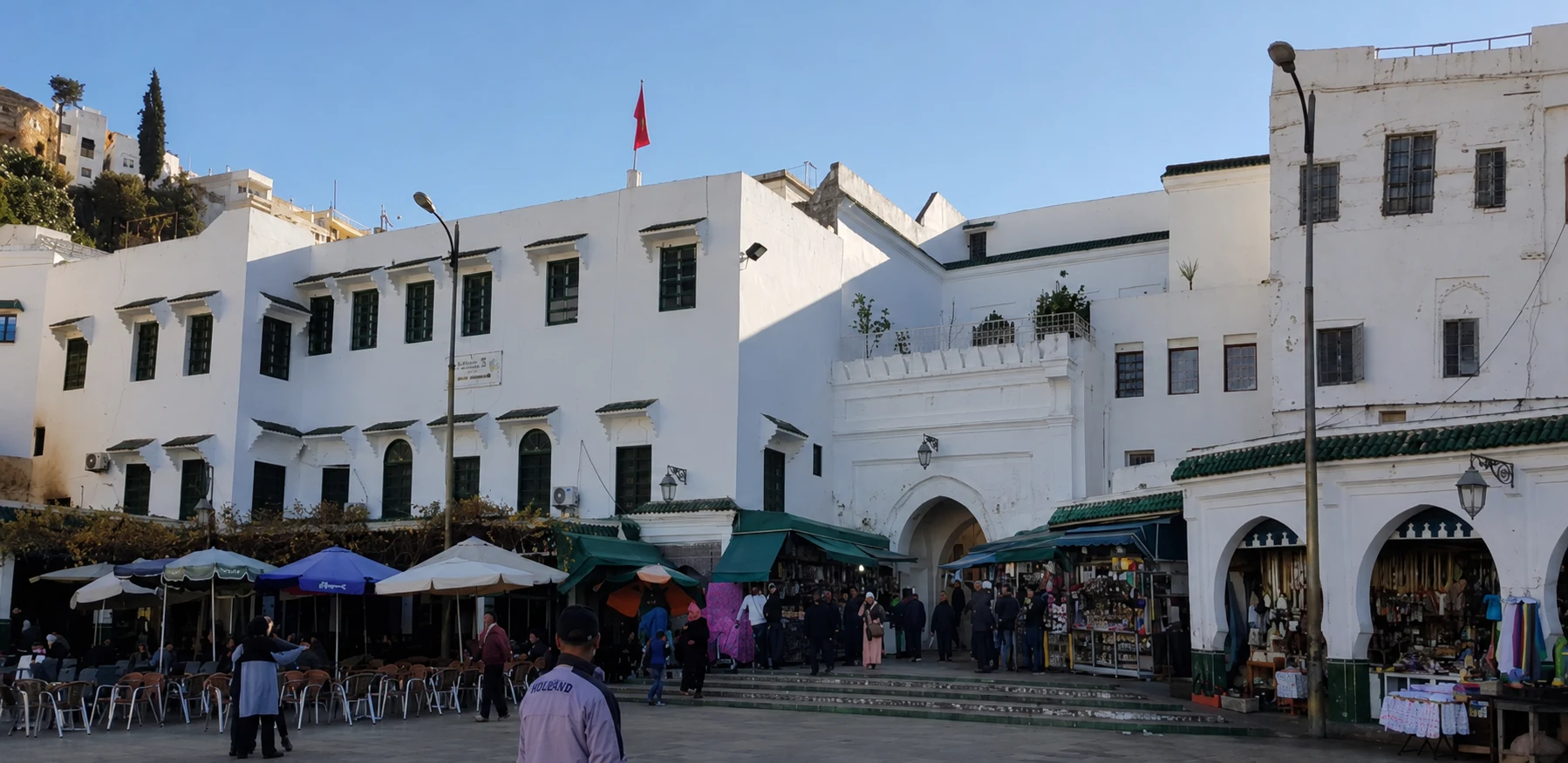 Whitewashed buildings and café umbrellas line the main square in Moulay Idriss.