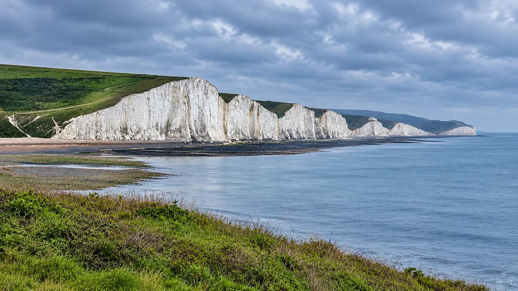 Seven Sisters white chalk cliffs on the East Sussex coast beneath a grey sky
