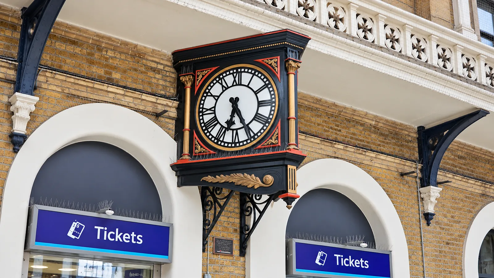 Ticket offices and a historic station clock at a London railway station