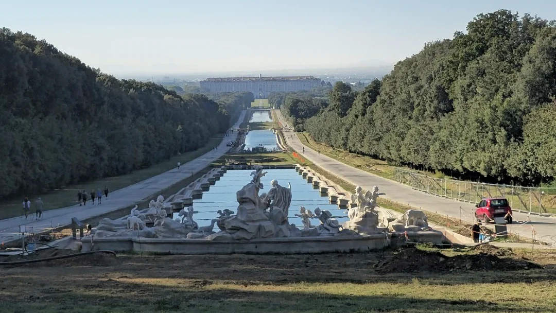 Sculptures and the long sequence of pools in the park of the Reggia di Caserta, with the palace in the distance.